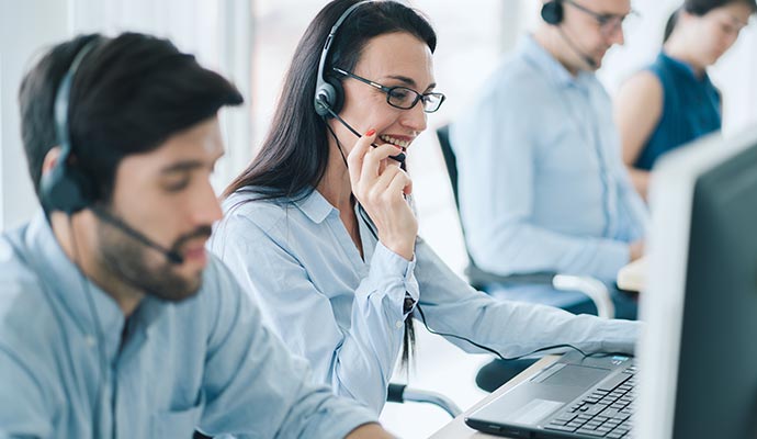 call center executives providing support over phone in their office