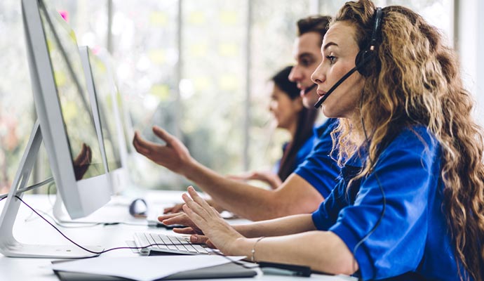 executives providing services over the phone in a call center office