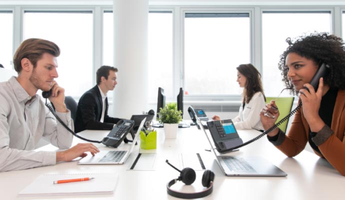 office workers talking over the telephone