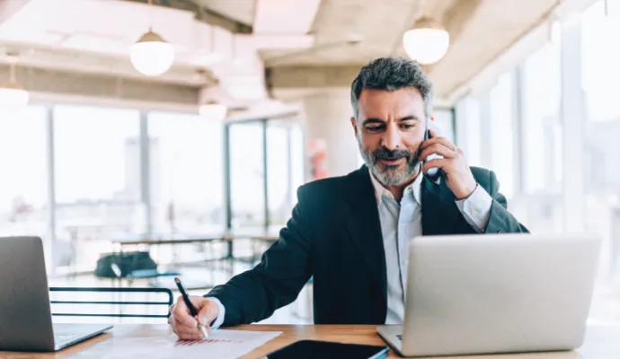 Business person multitasking at desk