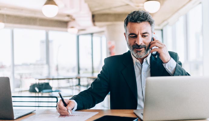 Business person multitasking at desk