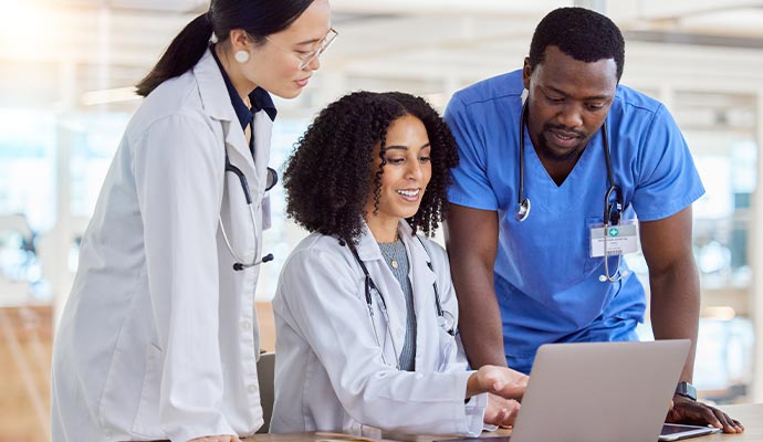 three healthcare professionals having a discussion