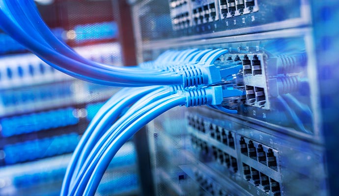 Blue network cables plugged into a server rack