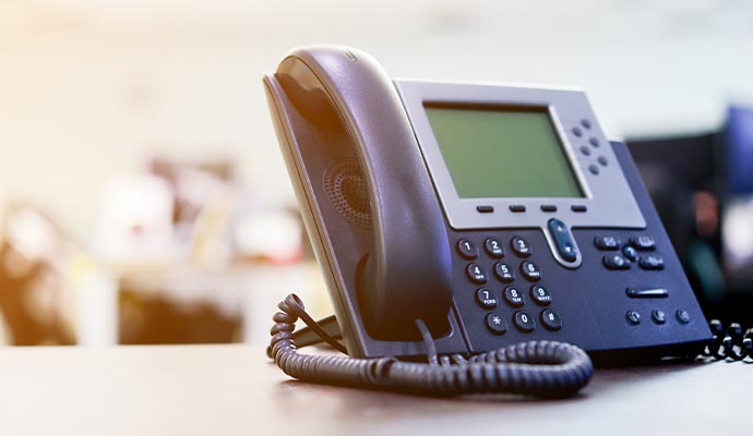 an installed telephone on top of a desk