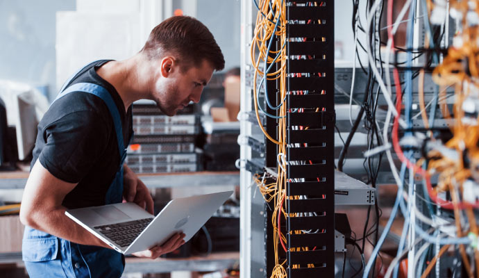 a professional technician inspecting wired network